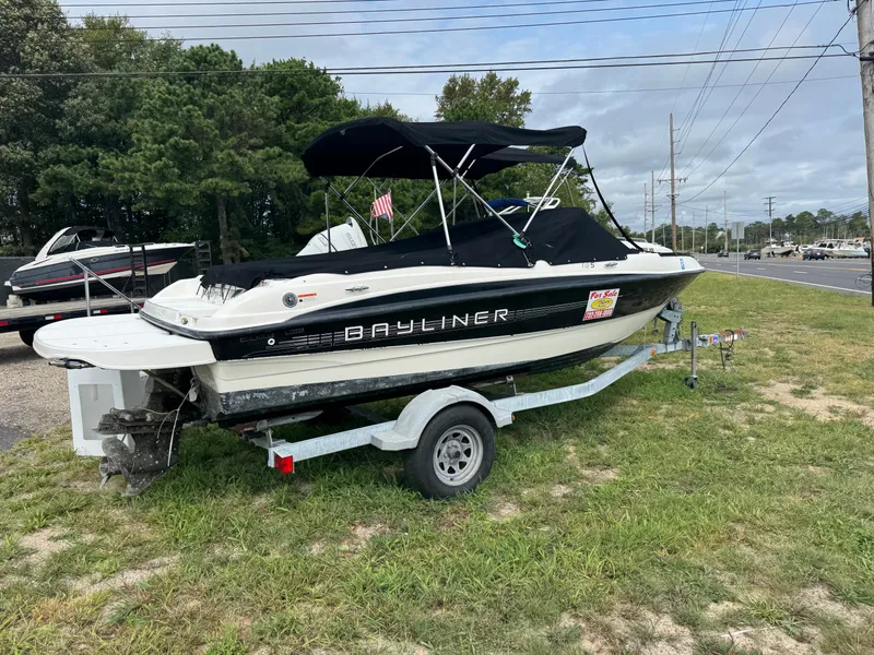 The Image of 2011 Bayliner 185 boat on trailer, parked on grass near road. - 0