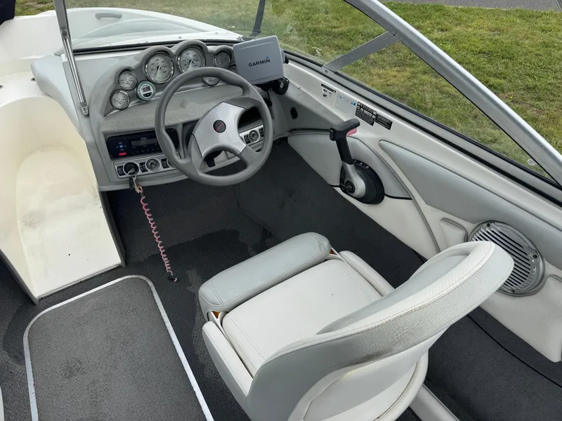 Slide: The Image of 2011 Bayliner 185 boat interior with steering wheel, gauges, and seating. - 3