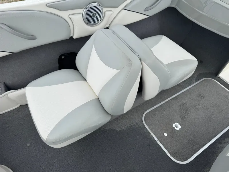 Slide: The Image of 2011 Bayliner 185 boat interior with gray and white seating and speaker. - 5