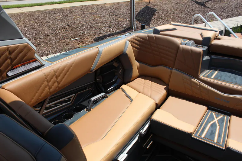 Slide: The Image of Luxurious interior seating of 2025 Tigé Ultré 23ZX boat with tan and black upholstery. - 12