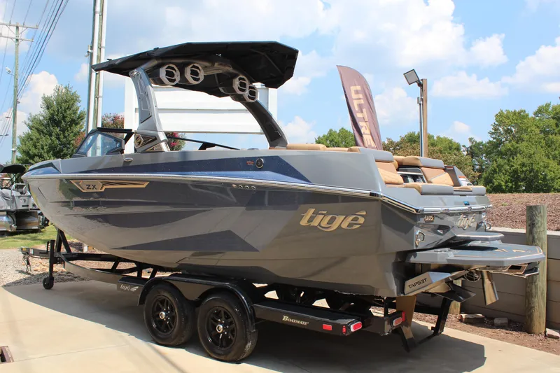 Slide: The Image of 2025 Tigé Ultré 23ZX boat on trailer, sleek design, outdoor display. - 3