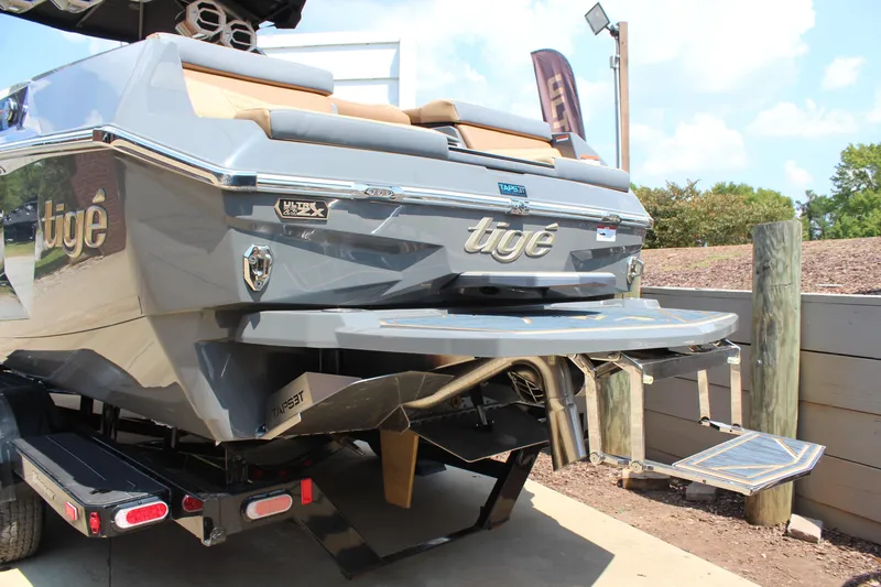 Slide: The Image of 2025 Tigé Ultré 23ZX boat rear view, showcasing sleek design and swim platform. - 4