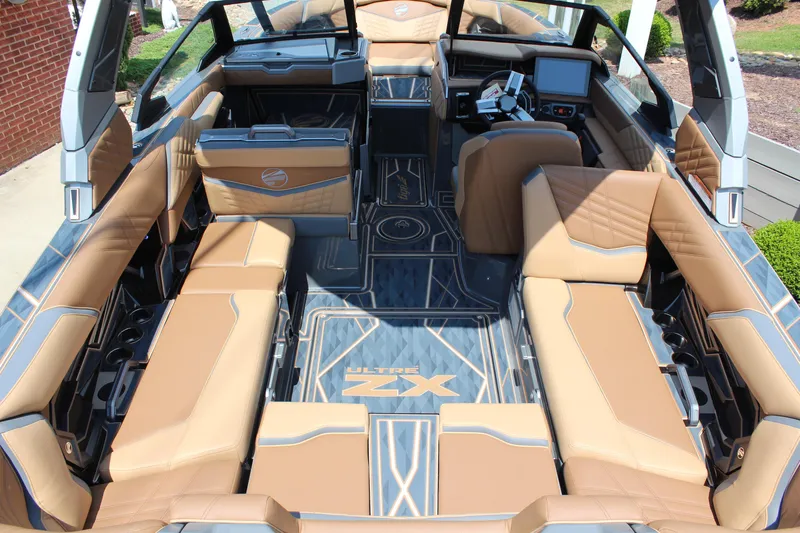 Slide: The Image of Luxurious interior of 2025 Tigé Ultré 23ZX boat with tan seating and modern dashboard. - 7