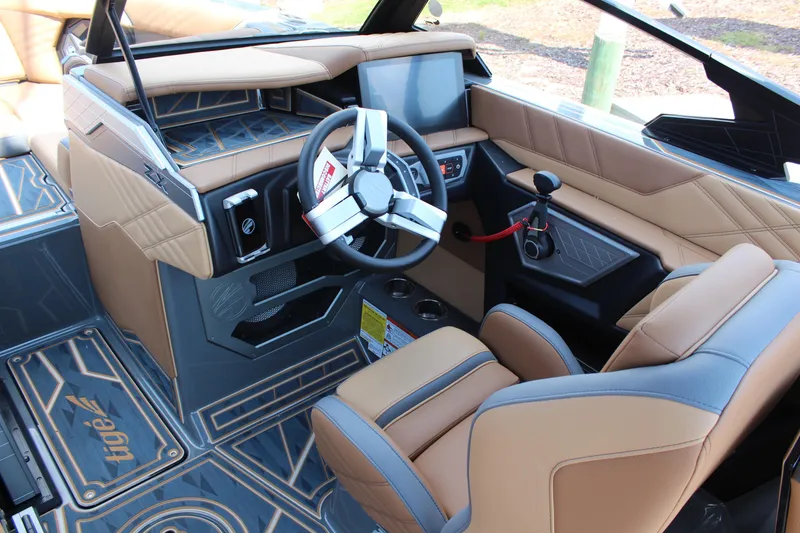 Slide: The Image of 2025 Tigé Ultré 23ZX boat interior with modern steering and dashboard design. - 8