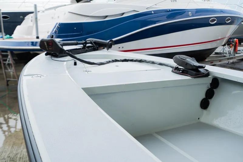 Slide: The Image of 1988 Baretta Success 185 boat in marina, with modern vessels in background. - 3