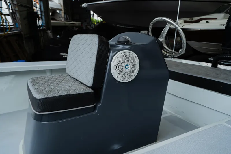 Slide: The Image of 1988 Baretta Success 185 boat interior with steering wheel and cushioned seat. - 4