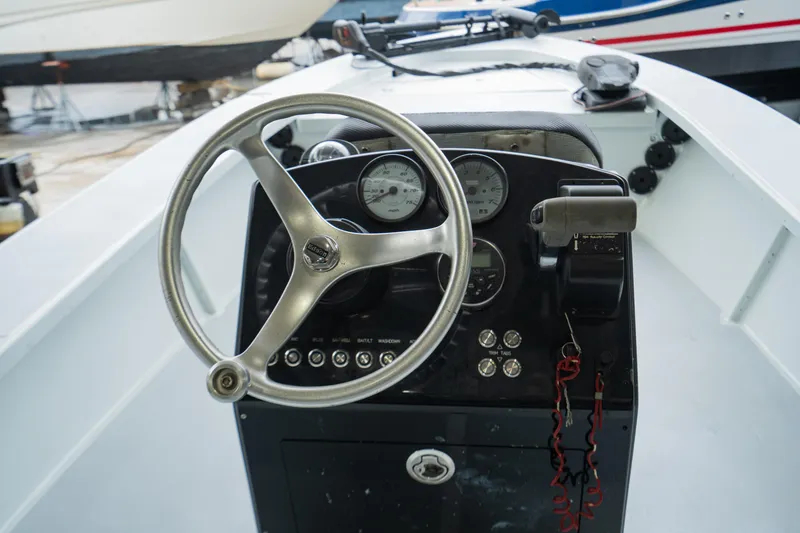 Slide: The Image of 1988 Baretta Success 185 boat dashboard with steering wheel and gauges. - 6