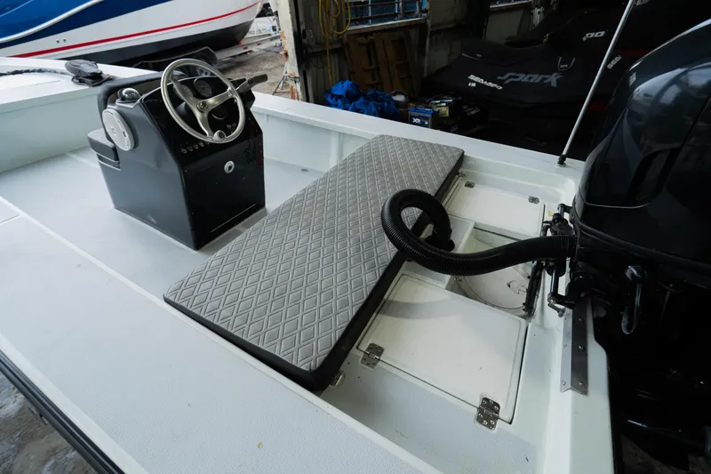 Slide: The Image of 1988 Baretta Success 185 boat interior with steering console and cushioned seating. - 8