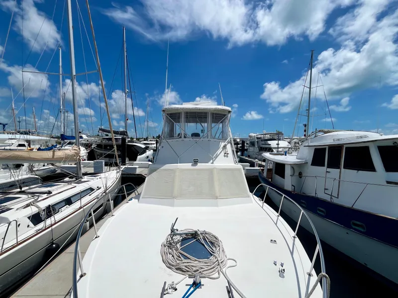 Slide: The Image of 1988 Jersey Dawn 40 yacht docked at marina under blue sky. - 12