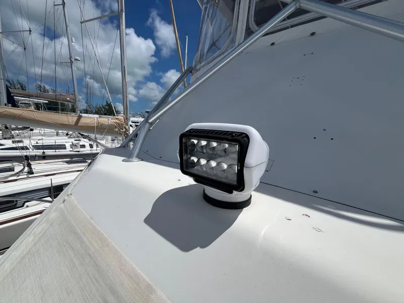 Slide: The Image of 1988 Jersey Dawn 40 boat with spotlight on deck, docked under blue sky. - 13