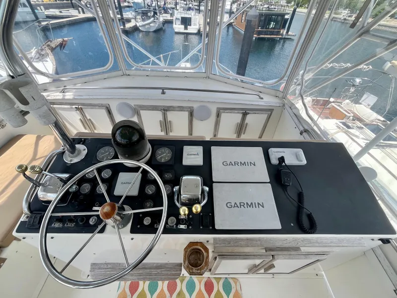 Slide: The Image of 1988 Jersey Dawn 40 boat helm with Garmin navigation, overlooking marina. - 16