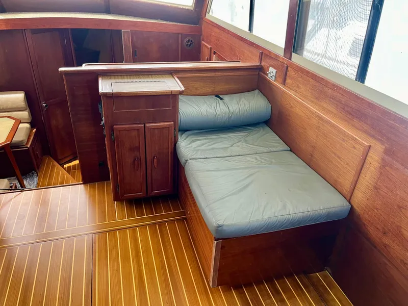 Slide: The Image of Interior of 1988 Jersey Dawn 40 boat with wooden flooring and cushioned seating. - 23