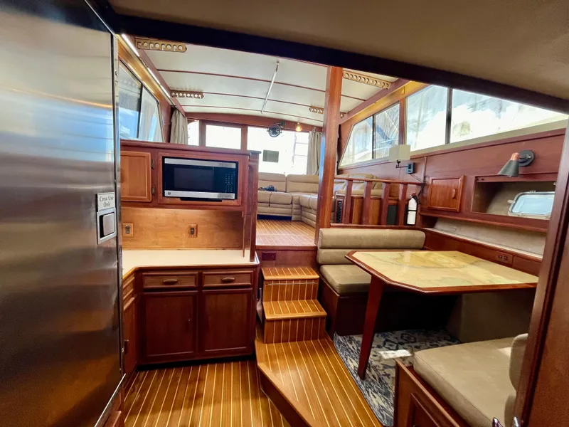 Slide: The Image of Interior of 1988 Jersey Dawn 40 yacht with wood finish and cozy seating area. - 24