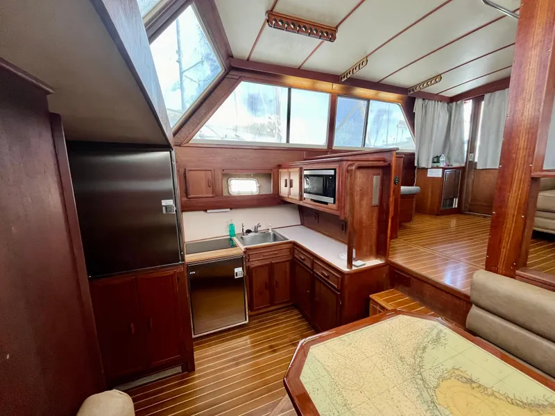 Slide: The Image of Interior of 1988 Jersey Dawn 40 yacht with wood finish and modern kitchen amenities. - 28