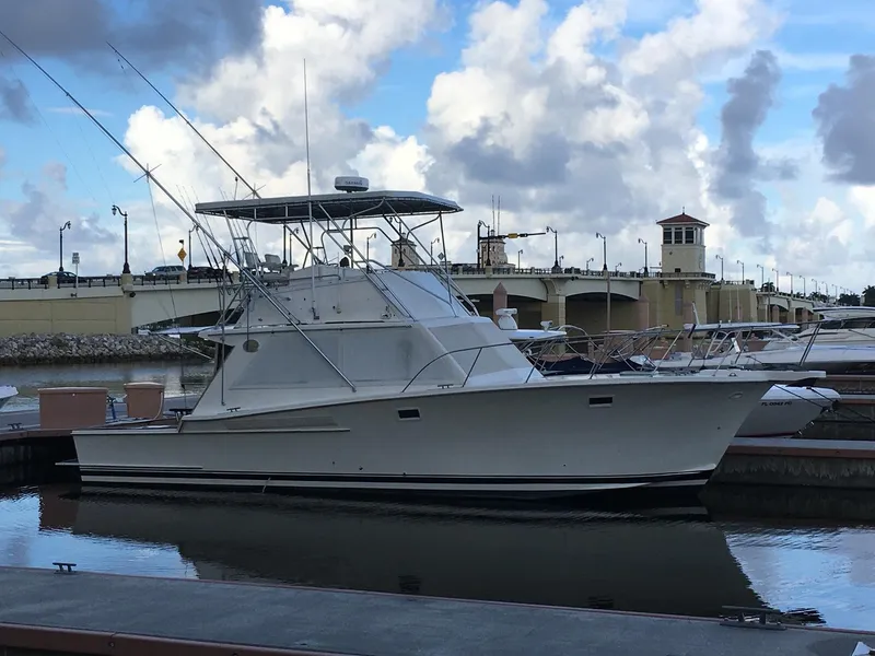 Slide: The Image of 1988 Jersey Dawn 40 yacht docked at marina under cloudy sky. - 3