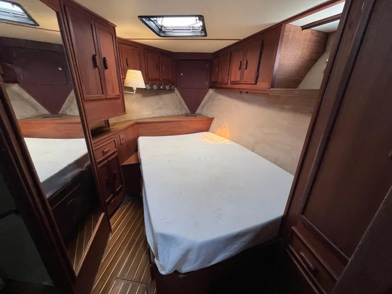 Slide: The Image of Cozy cabin interior of 1988 Jersey Dawn 40 yacht with wood paneling and bed. - 32
