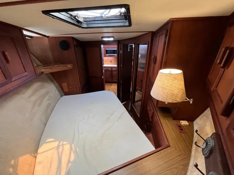 Slide: The Image of 1988 Jersey Dawn 40 yacht interior with cozy cabin, bed, and wooden furnishings. - 33