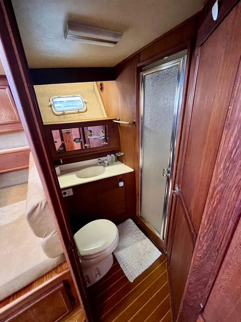 Slide: The Image of 1988 Jersey Dawn 40 yacht bathroom with wood paneling and shower. - 34