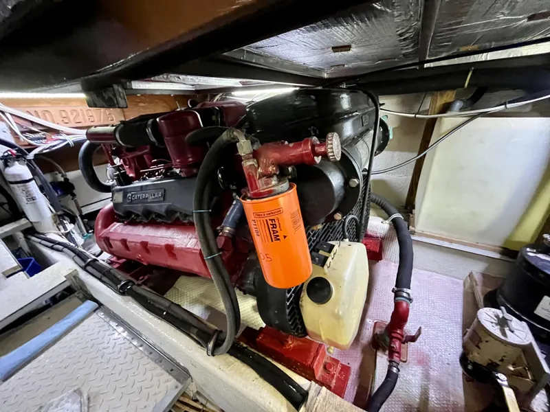 Slide: The Image of Engine room of 1988 Jersey Dawn 40 boat with visible components and filters. - 35