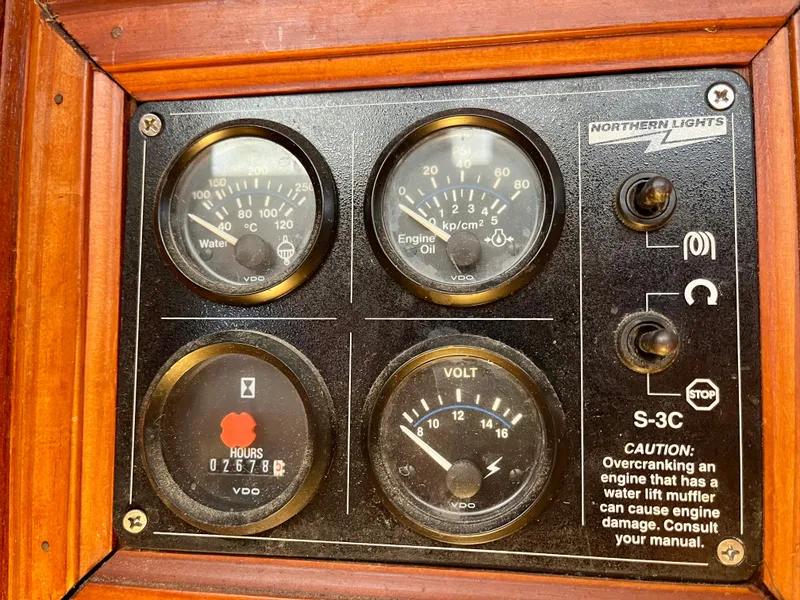 Slide: The Image of Control panel of a 1988 Jersey Dawn 40 boat with gauges and caution label. - 38