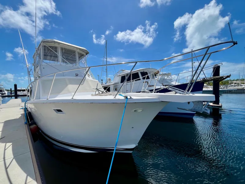Slide: The Image of 1988 Jersey Dawn 40 yacht docked at marina under clear blue sky. - 4