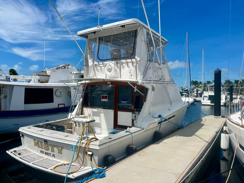 Slide: The Image of 1988 Jersey Dawn 40 yacht docked at marina under clear blue sky. - 6