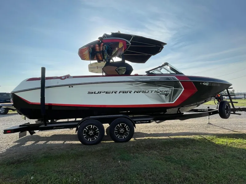 Slide: The Image of 2019 Nautique Super Air Nautique G25 boat on trailer, side view, outdoors. - 0