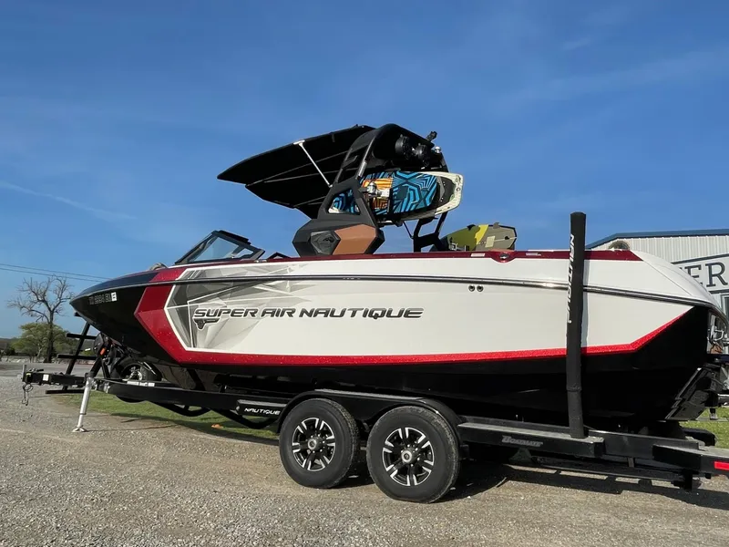 Slide: The Image of 2019 Nautique Super Air Nautique G25 boat on trailer, side view, sunny day. - 1