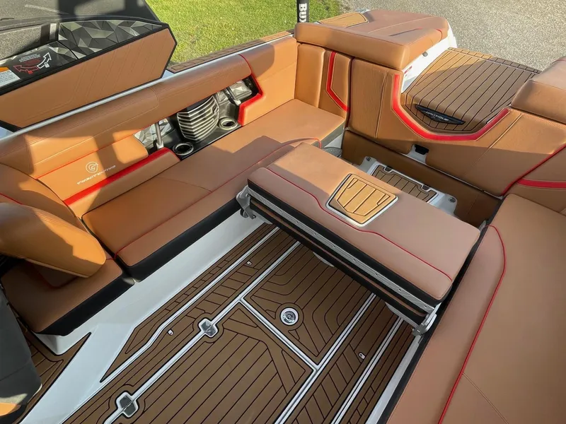 Slide: The Image of 2019 Nautique Super Air Nautique G25 interior with tan seating and teak-style flooring. - 11