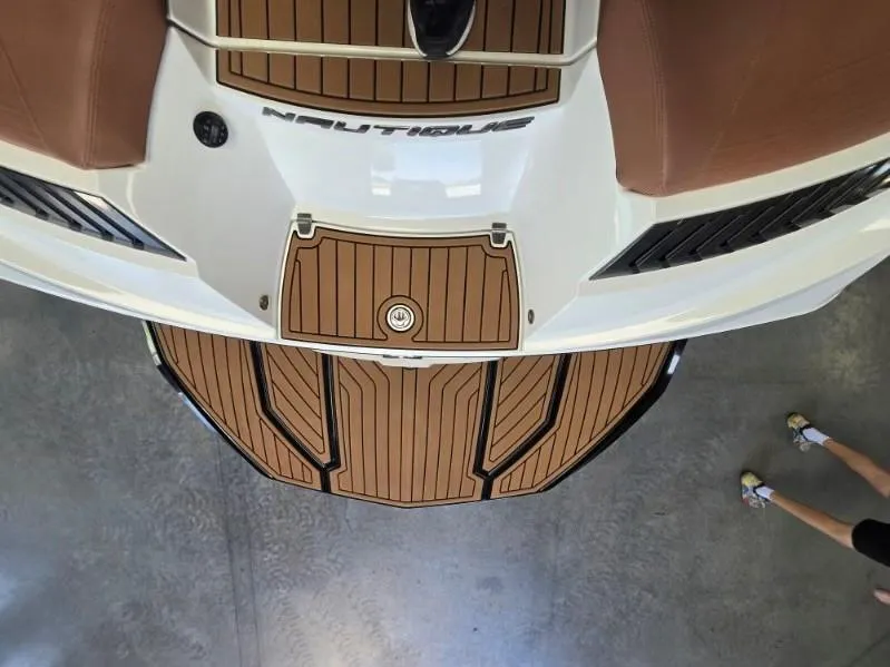 Slide: The Image of 2019 Nautique Super Air Nautique G25 boat deck with teak flooring, viewed from above. - 13