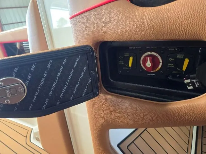 Slide: The Image of Control panel of a 2019 Nautique Super Air Nautique G25 boat interior. - 16