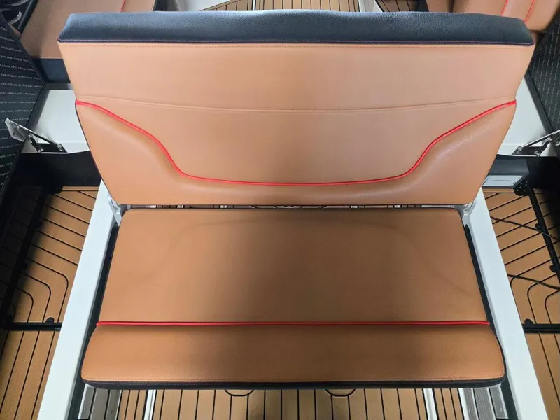 Slide: The Image of 2019 Nautique Super Air Nautique G25 tan and red boat seat detail. - 22