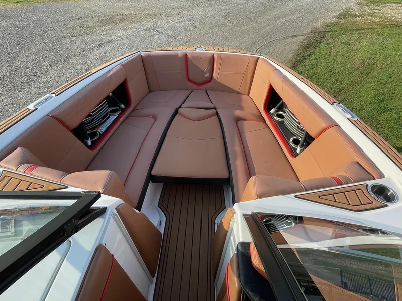 Slide: The Image of 2019 Nautique Super Air Nautique G25 boat interior with tan seating and cup holders. - 5