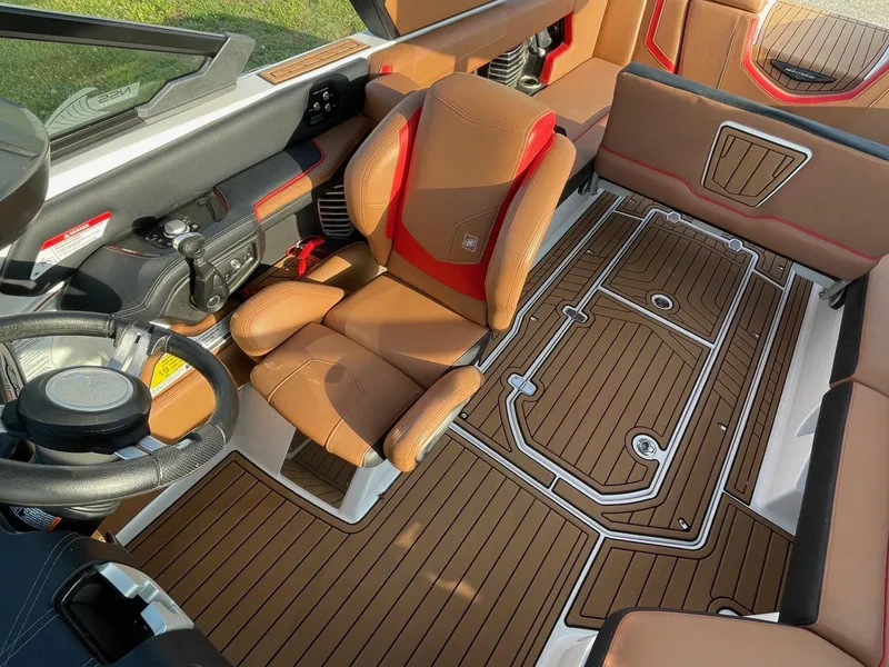 Slide: The Image of 2019 Nautique Super Air Nautique G25 interior with brown seating and detailed flooring. - 6