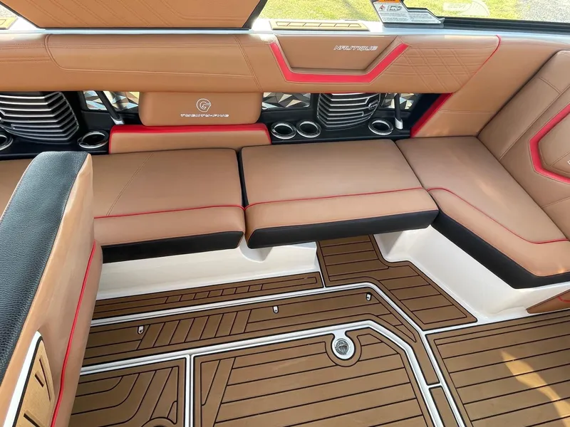 Slide: The Image of 2019 Nautique Super Air Nautique G25 interior with tan and red seating, stylish flooring. - 9