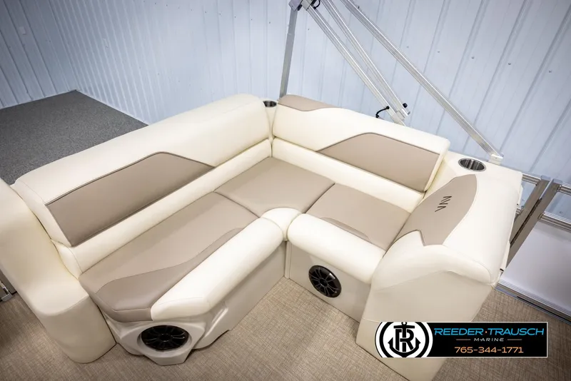 Slide: The Image of 2025 Avalon VEN CRB boat interior with beige and cream seating, cup holders, and speakers. - 22
