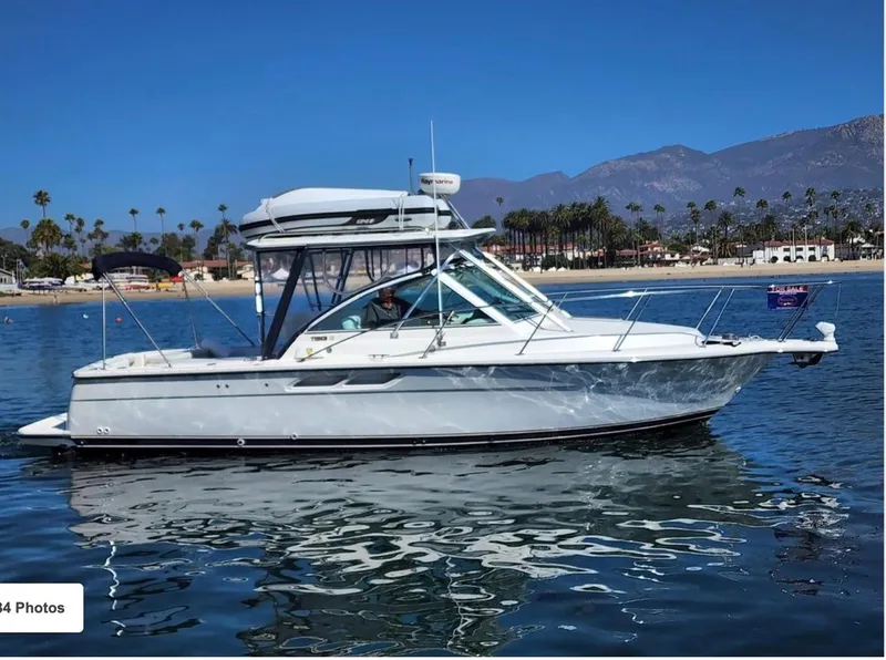 The Image of 2003 Tiara Yachts 2900 Coronet on calm water with scenic coastal backdrop. - 0