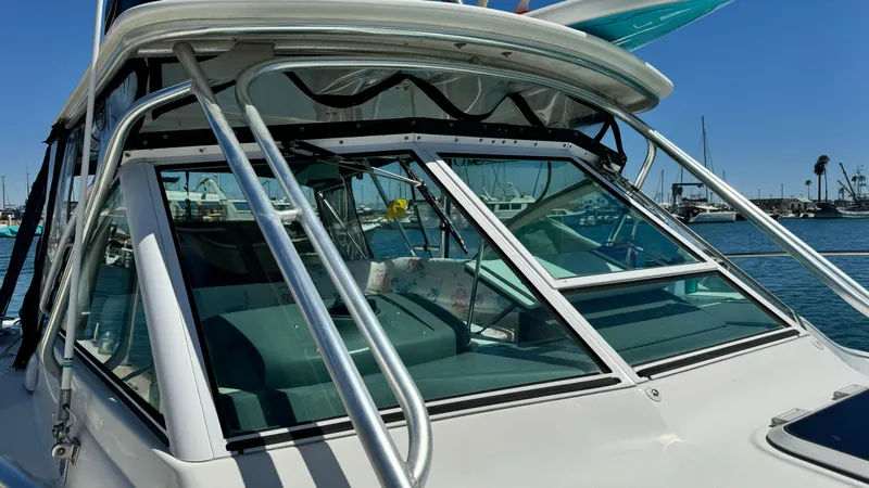 Slide: The Image of 2003 Tiara Yachts 2900 Coronet boat with sleek design, docked in a marina. - 10
