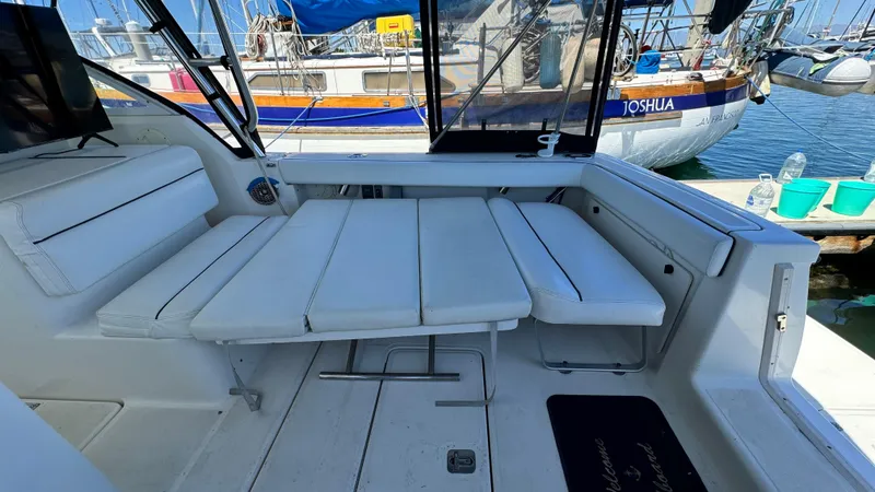 Slide: The Image of 2003 Tiara Yachts 2900 Coronet interior with white seating, docked at marina. - 11