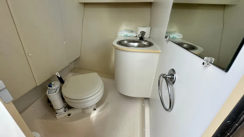 Slide: The Image of 2003 Tiara Yachts 2900 Coronet bathroom with toilet, sink, and mirror. - 16