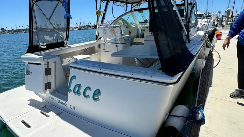 Slide: The Image of 2003 Tiara Yachts 2900 Coronet docked, featuring open deck and sleek design. - 17