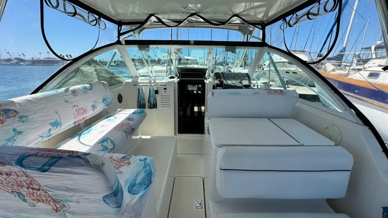 Slide: The Image of 2003 Tiara Yachts 2900 Coronet interior with seating and helm, docked at marina. - 6