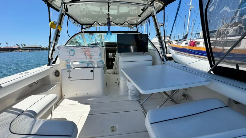 Slide: The Image of 2003 Tiara Yachts 2900 Coronet interior with seating and table, docked in a marina. - 8