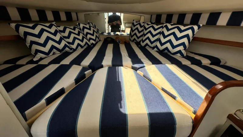 Slide: The Image of 2003 Tiara Yachts 2900 Coronet cabin with striped bedding and chevron pillows. - 9