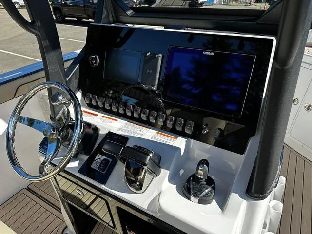 Slide: The Image of 2025 Yamaha Boats 255 FSH Sport H dashboard with steering wheel and control panel. - 10