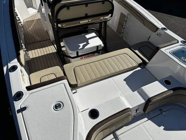Slide: The Image of 2025 Yamaha Boats 255 FSH Sport H interior with seating and storage. - 12