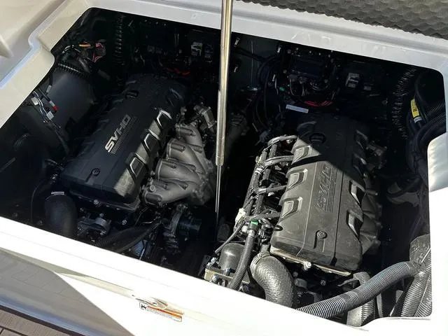 Slide: The Image of 2025 Yamaha Boats 255 FSH Sport H engine compartment with twin engines. - 14
