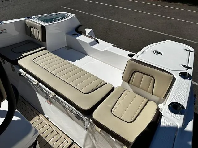 Slide: The Image of 2025 Yamaha Boats 255 FSH Sport H interior with beige seating and sleek design. - 3