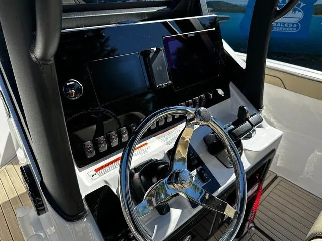 Slide: The Image of 2025 Yamaha Boats 255 FSH Sport H dashboard with steering wheel and controls. - 5