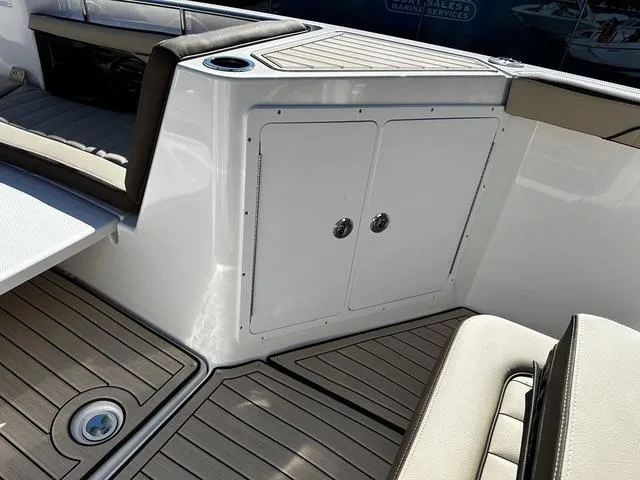 Slide: The Image of 2025 Yamaha Boats 255 FSH Sport H interior with seating and storage compartments. - 6